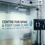 A physiotherapist conducting a detailed sports gait analysis in an Indore clinic, showing real-time biomechanical data of an athlete running on a sophisticated treadmill system to diagnose causes of leg pain during walking.